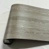 Roll of wood grain peel and stick wall decals showing natural light gray wood texture