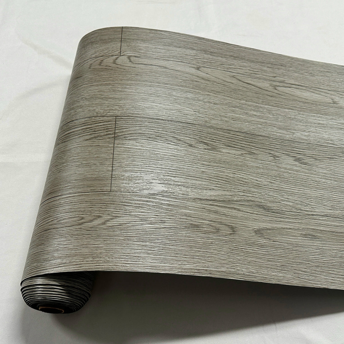 Roll of wood grain PVC self-adhesive decal showing natural light gray texture