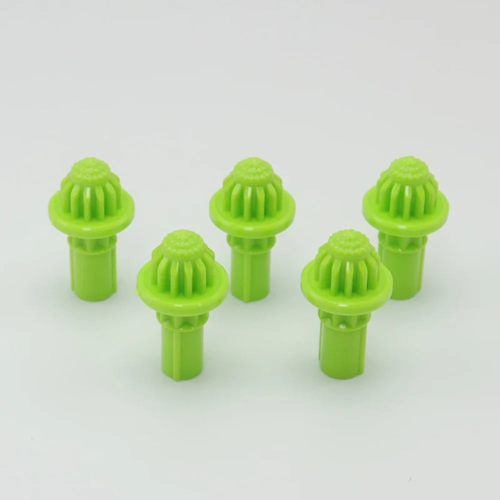 A set of five bright green replacement drivers for a Battling Top, featuring a textured top and cylindrical base.