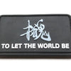 Black embroidered patch featuring a stylized dragon character and the text TO LET THE WORLD BE