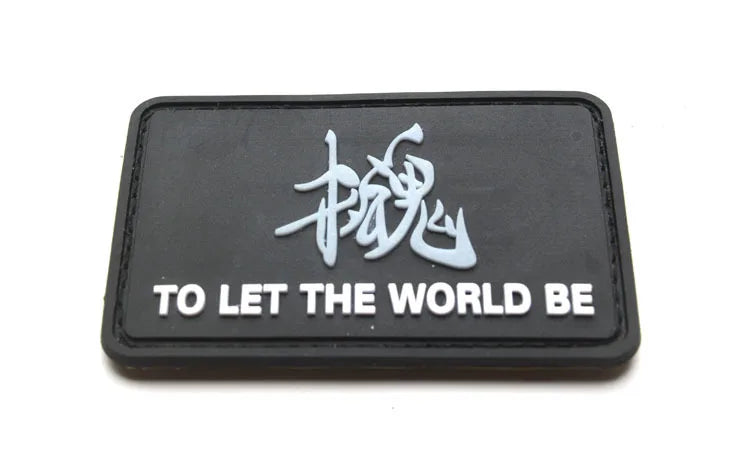 Black embroidered patch featuring a stylized dragon character and the text TO LET THE WORLD BE