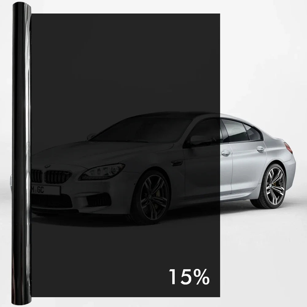 A silver BMW sedan with a black privacy tint film applied to the windows.