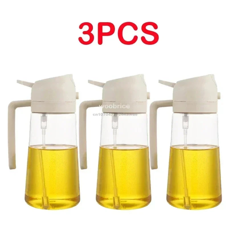 Three clear glass oil spray bottles with white pump tops and yellow oil inside