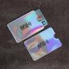 A set of ten plastic RFID blocking card sleeves with a rainbow iridescent finish are displayed on a dark brown surface.