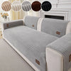 A light gray minimalist sofa cushion cover with striped fabric and decorative accent circles.