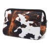 A black and white cow print waterproof neoprene cosmetic bag with a zipper.
