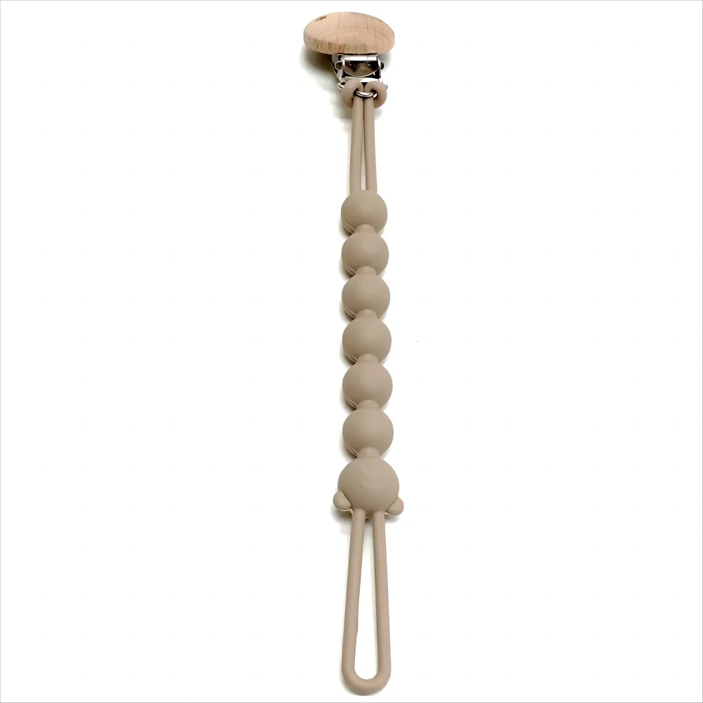 A light beige silicone pacifier clip with an anti-lost chain and wooden top.