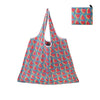 A reusable shopping tote bag patterned with sliced watermelon pieces in red and green on a blue background.