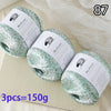 Three balls of glitter yarn labeled MuYuan Frost Words are displayed on a light surface.
