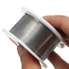 A hand holds a spool of rosin core solder wire in a clear plastic casing.