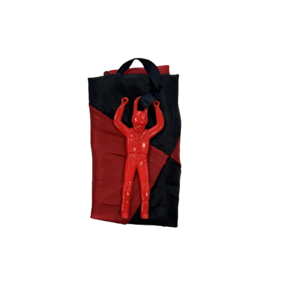 A red mini soldier figure is visible inside a black and red parachute toy bag.