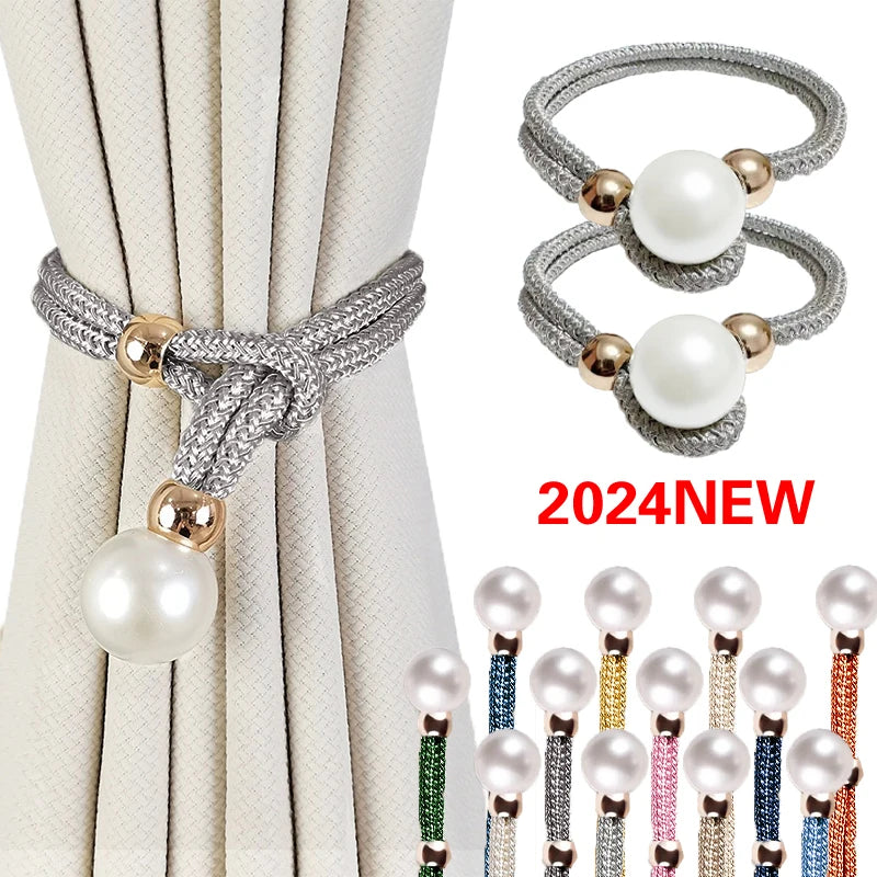 Set of two silver and gold pearl rope curtain tie-backs displayed against a light fabric backdrop.