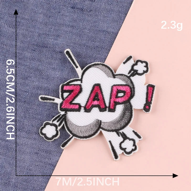 A white embroidered lettering patch with the word ZAP in pink and black, featuring a cloud design.