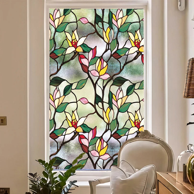 Floral stained glass window film featuring pink, yellow, and green leaves on a dark background.