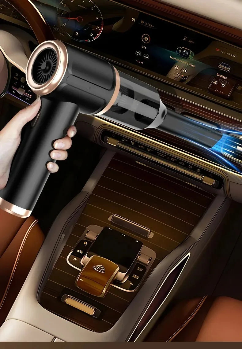 A hand holds a powerful cordless handheld vacuum with a long tube and blue light, positioned near a car's interior controls.