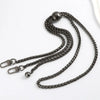 A close-up of an elegant dark metal chain strap for handbags and purses.
