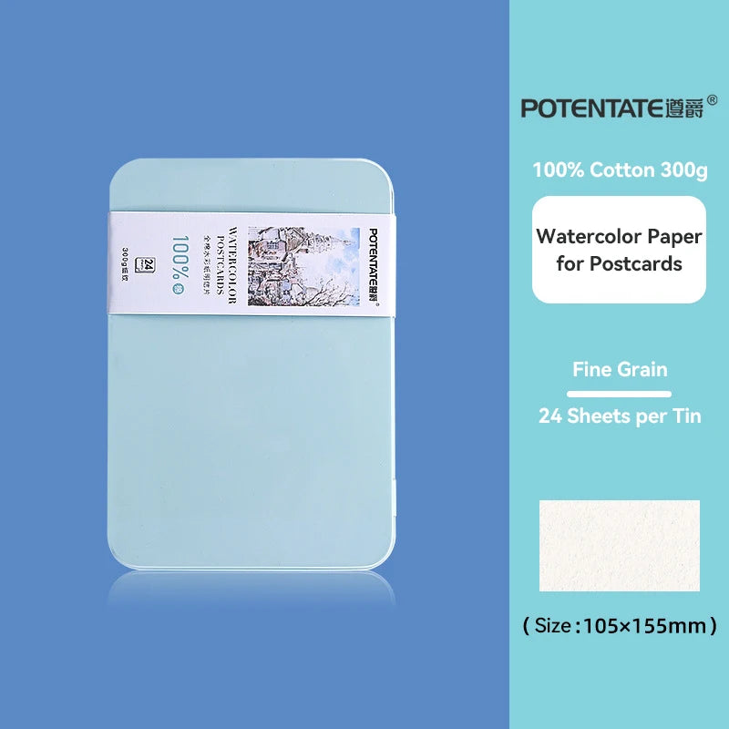 A light blue tin box containing 24 sheets of 100% cotton watercolor paper for postcards.