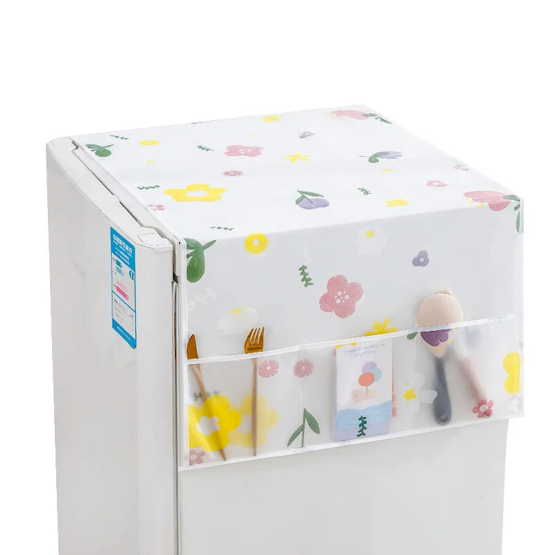 A white refrigerator dust cover with floral patterns and storage pockets for food items.