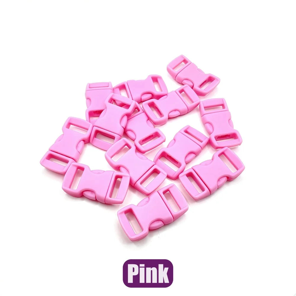 A pile of pink plastic side-release buckles for paracord bracelet projects.