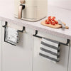 A white punch-free over-cabinet towel rack mounted under a kitchen cabinet, with a striped towel and a knife on the counterto