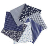 A bundle of nine cotton fabric squares featuring various patterns including stripes, stars, polka dots, and floral prints.
