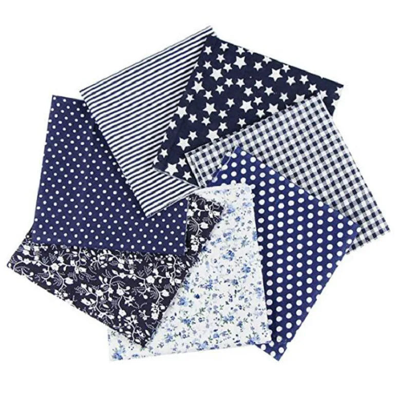 A bundle of nine cotton fabric squares featuring various patterns including stripes, stars, polka dots, and floral prints.
