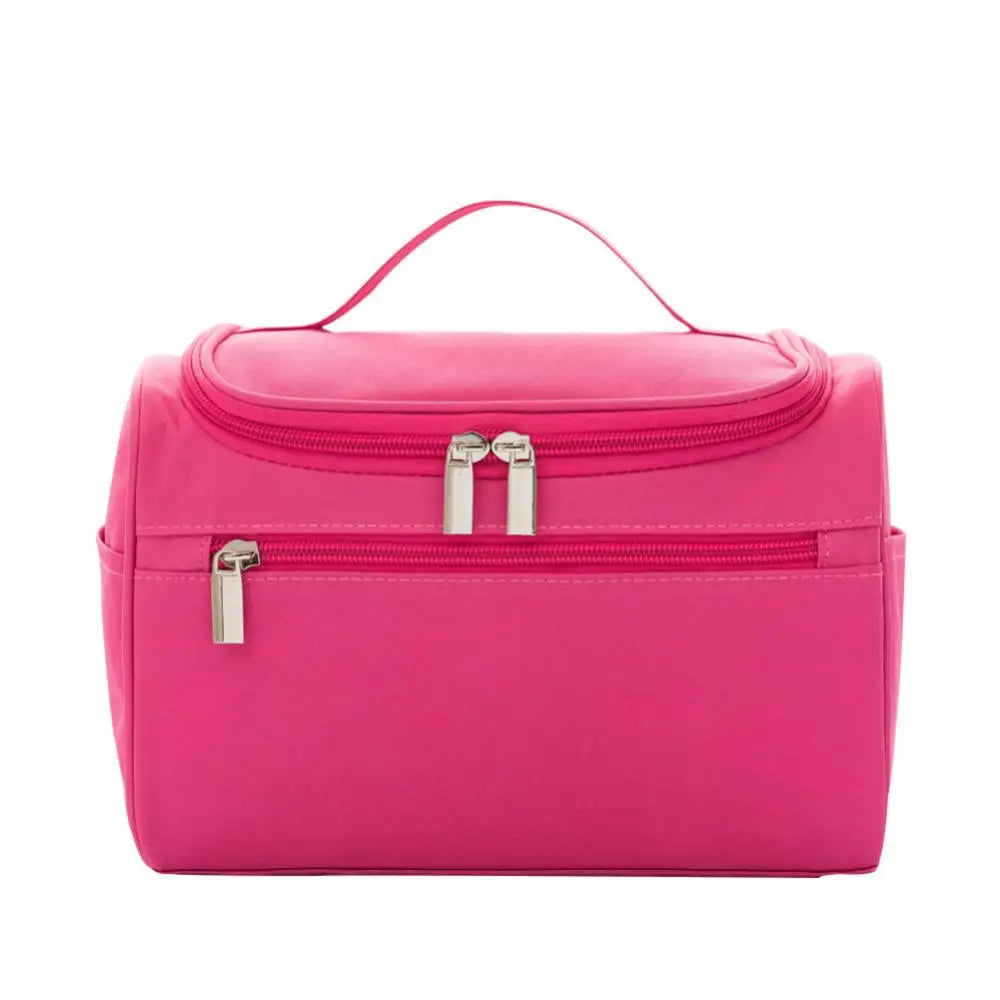 A bright pink hanging makeup bag with a zipper closure is shown against a white background.