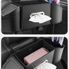A black car back seat organizer showing a cup holder, trash bin, and phone mount with a white napkin.