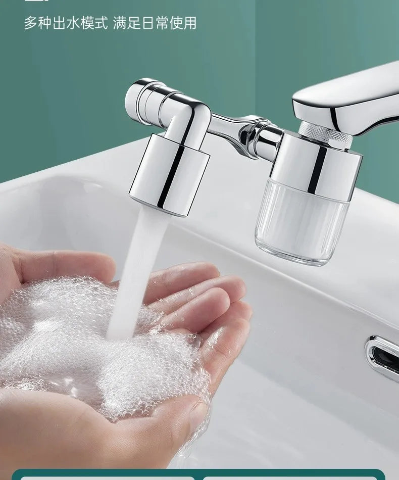 A hand is holding a clear faucet extender, which is dispensing a stream of water into the palm of the hand.