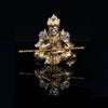 Gold hand-painted Monkey King figurine holding a staff, displayed against a black background.