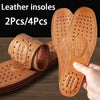 A hand holds a pair of genuine leather insoles, showing the textured sole design and thickness.