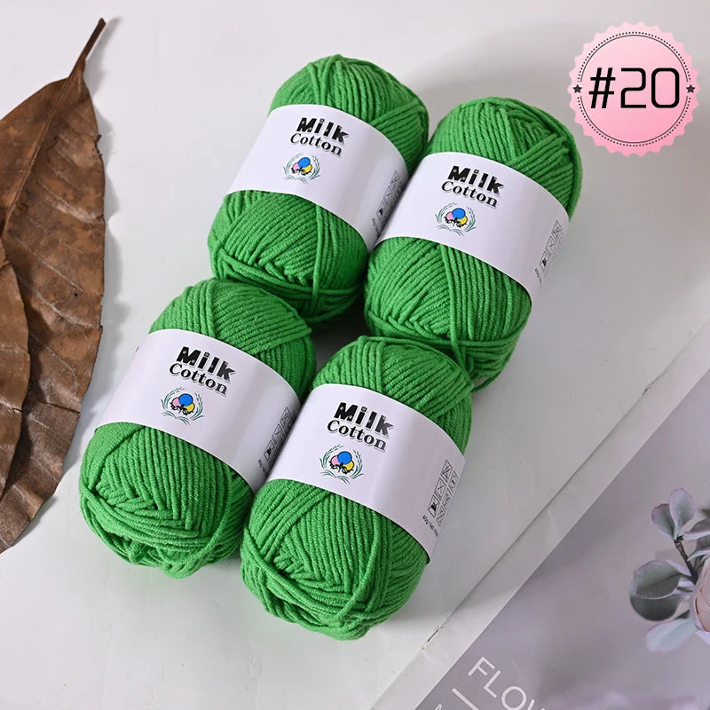A bundle of bright green Milk Cotton yarn is displayed on a white surface.