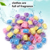 A pile of colorful water-soluble laundry fragrance beads in purple, blue, and yellow are shown against a light background.