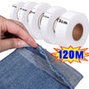 A hand is unwrapping a roll of white double-sided iron-on fabric adhesive tape, showing various tape widths.