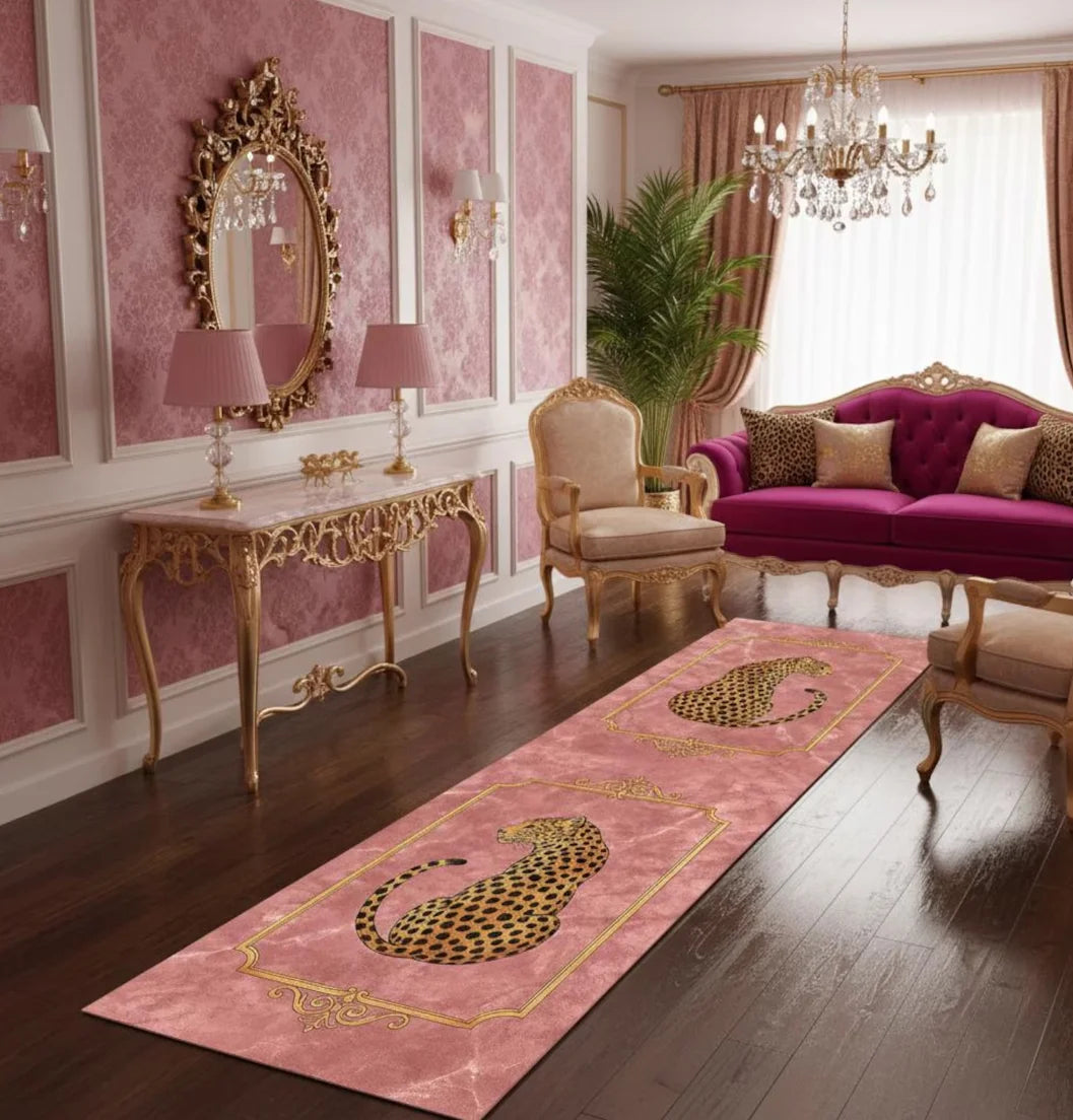 A pink runner rug with a gold leopard print design on a dark wood floor in an elegant room.