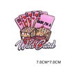 A set of pink and red embroidered letter patches featuring hearts and the text Wild Card.