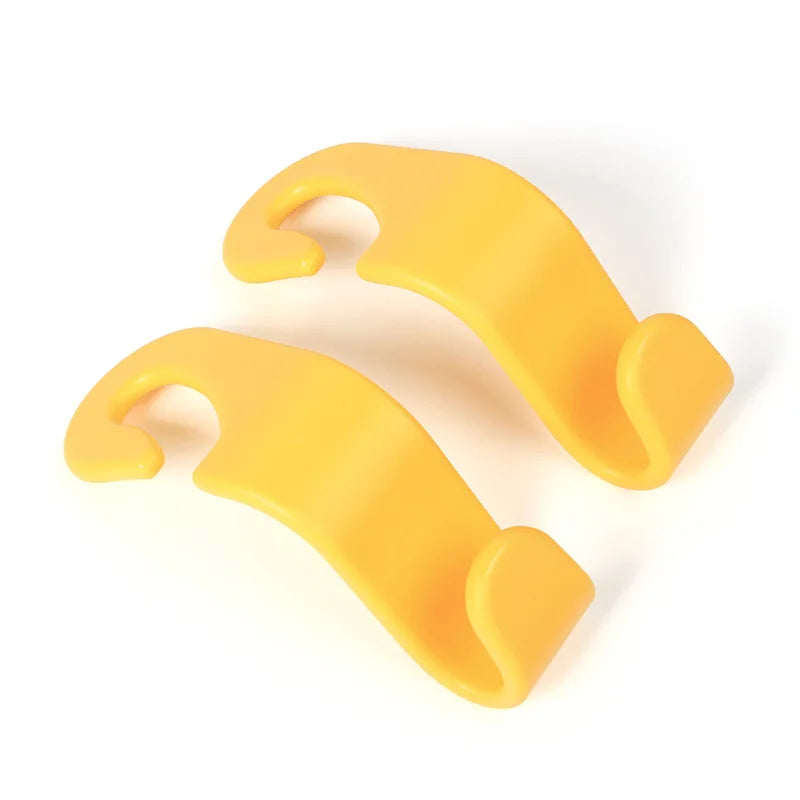 A pair of yellow universal car seat headrest hooks.