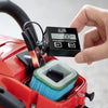 A hand holds a digital tachometer and hour meter device attached to a red power tool.