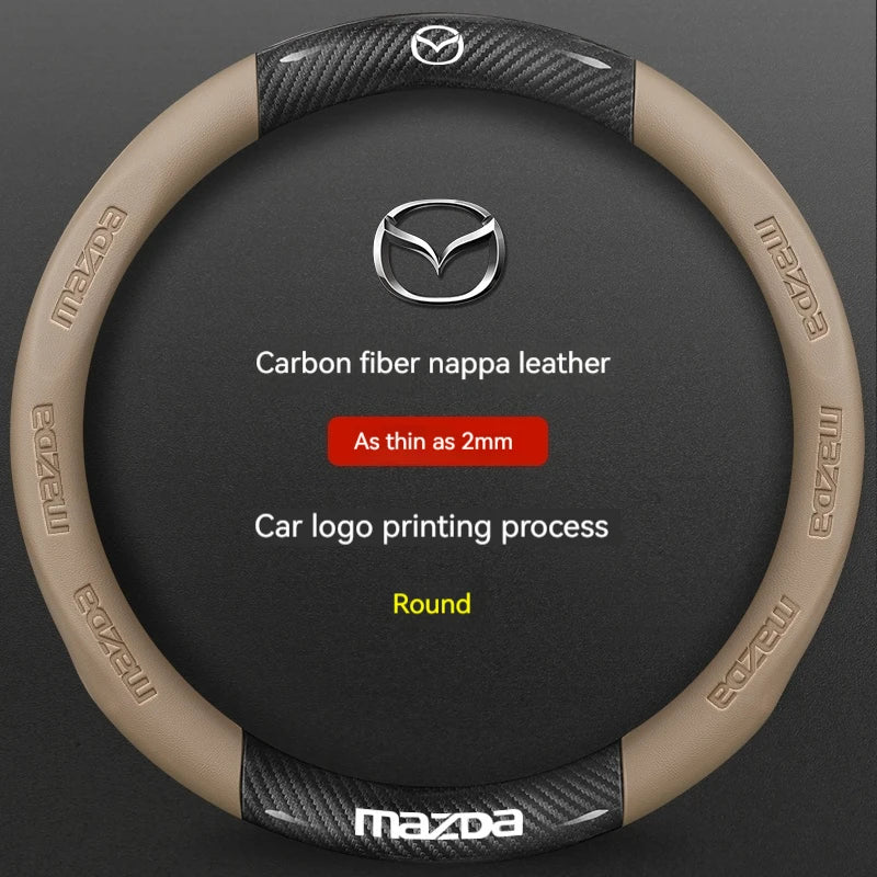 A round steering wheel cover made of tan carbon fiber nappa leather with a silver Mazda logo printing process.