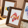 A set of twelve framed cross stitch kits featuring colorful sea life animals in wooden frames.