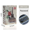 A close-up of a hidden book safe with a combination lock and an Eiffel Tower themed card.