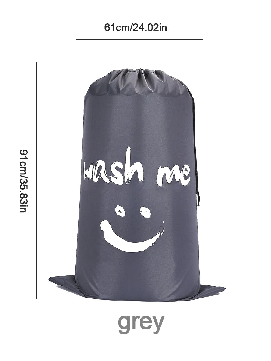 A grey drawstring laundry bag with the text wash me printed on it.