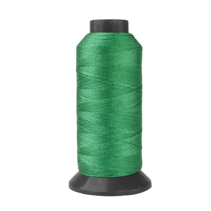 A spool of heavy-duty green nylon sewing thread for upholstery and denim.