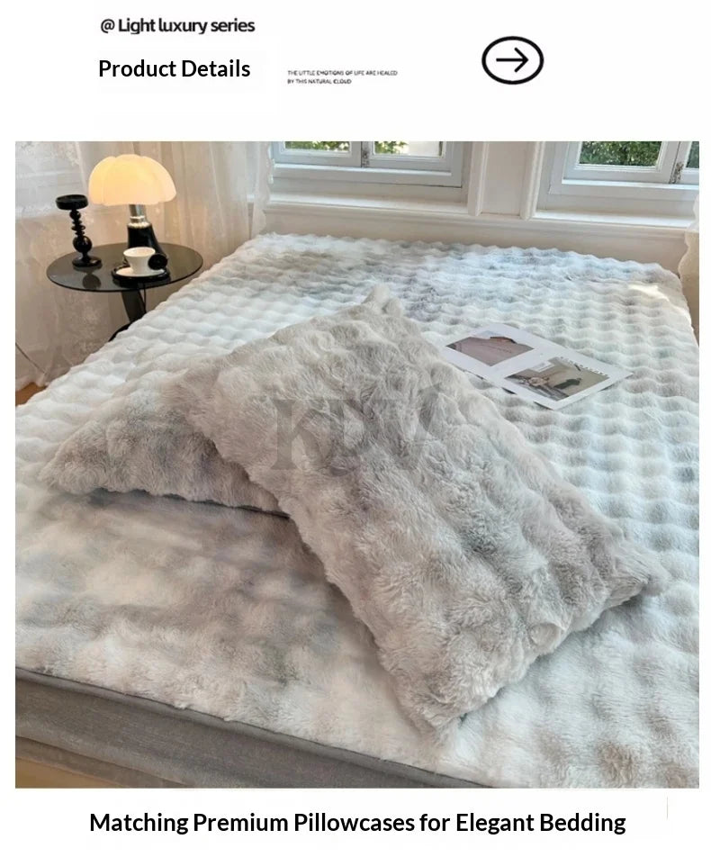 A fluffy, light gray faux fur fitted sheet and matching pillowcases are displayed on a bed with natural light.
