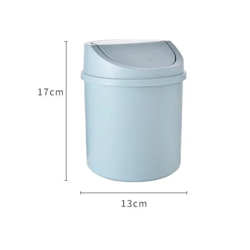 A light blue compact covered desktop trash bin with a flip lid.