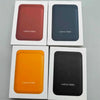 Three leather wallet cases in maroon, blue, and orange colors displayed in white packaging.