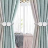 Light green and beige curtains with pearl magnetic tiebacks framing a bright window.