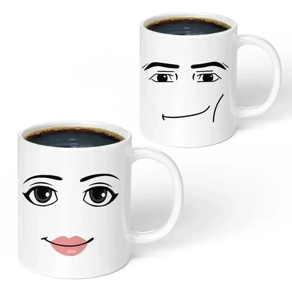 A white ceramic coffee mug featuring a cartoon face with a surprised expression.