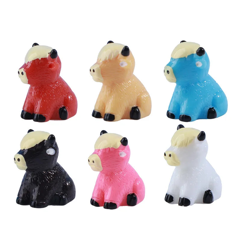A set of six colorful resin highland cow figurines in various colors including red, yellow, blue, black, pink, and white.