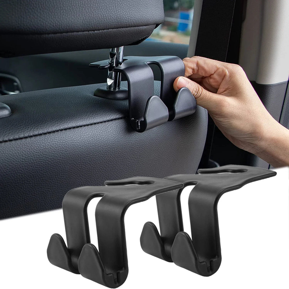 A hand is shown using black universal car headrest hooks to hang a handbag or coat.